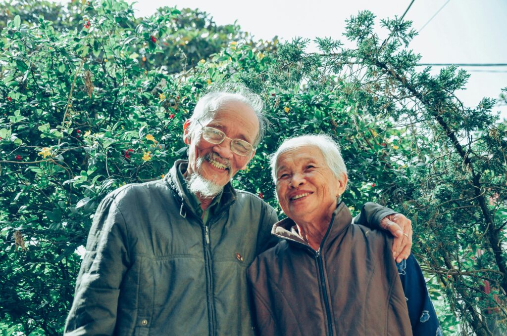 Senior couple sharing a joyful moment in a lush garden